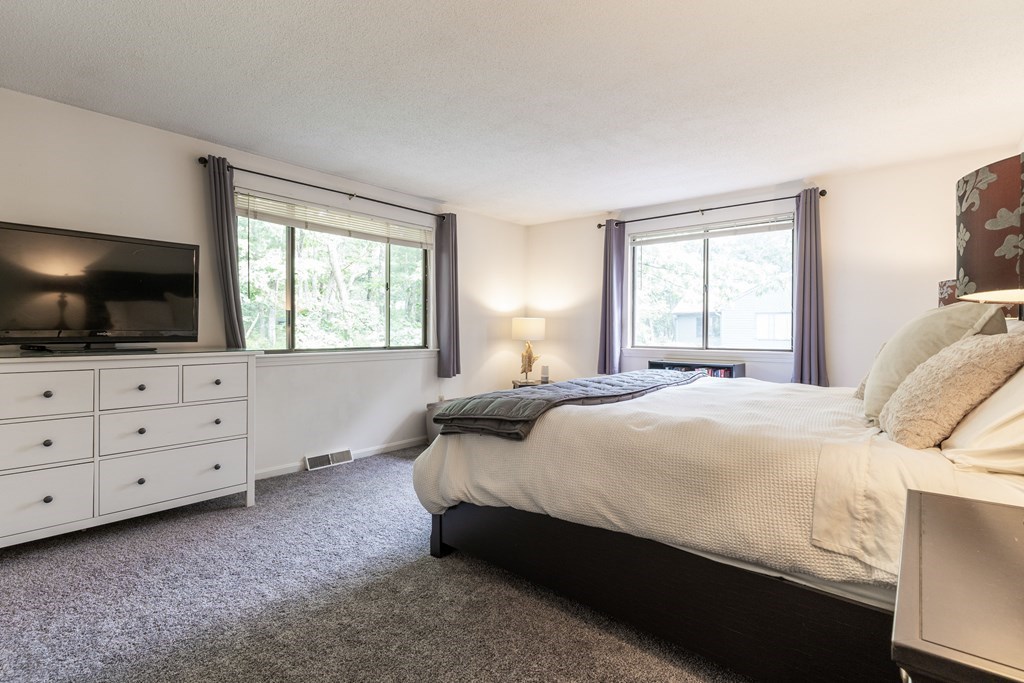 46 Mountain Gate Road, Unit 46 Ashland, MA 01721 - Photo 10 of 14 a bedroom with a bed and flat screen tv