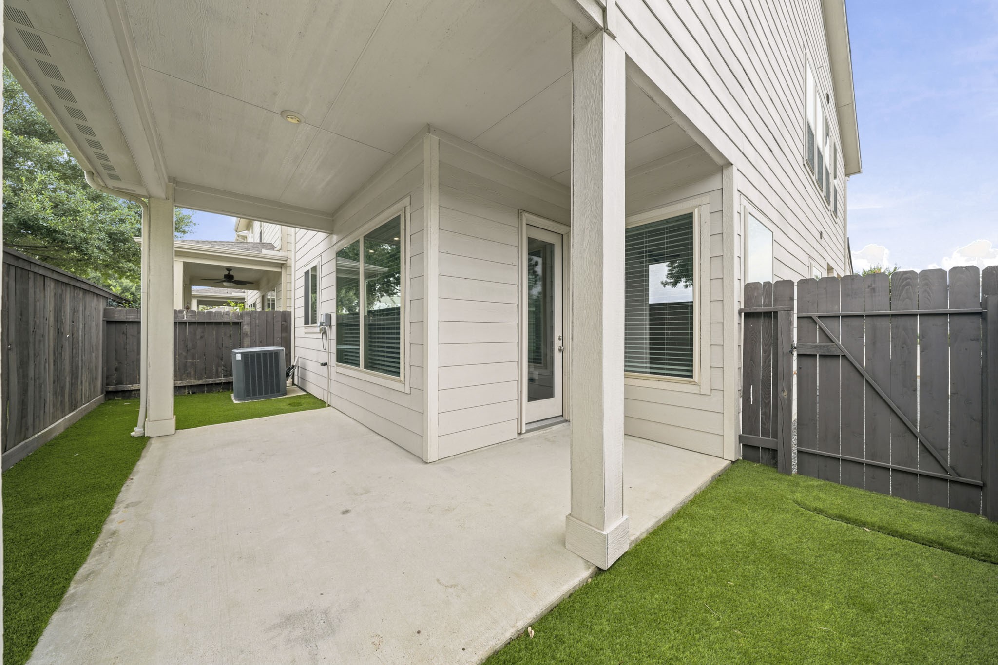 4103 Tranquil Square Road Houston, TX 77043 - Photo 34 of 39 Expansive covered patio overlooks a fully artificial turfed backyard, creating a low-maintenance outdoor retreat designed for year-round enjoyment.