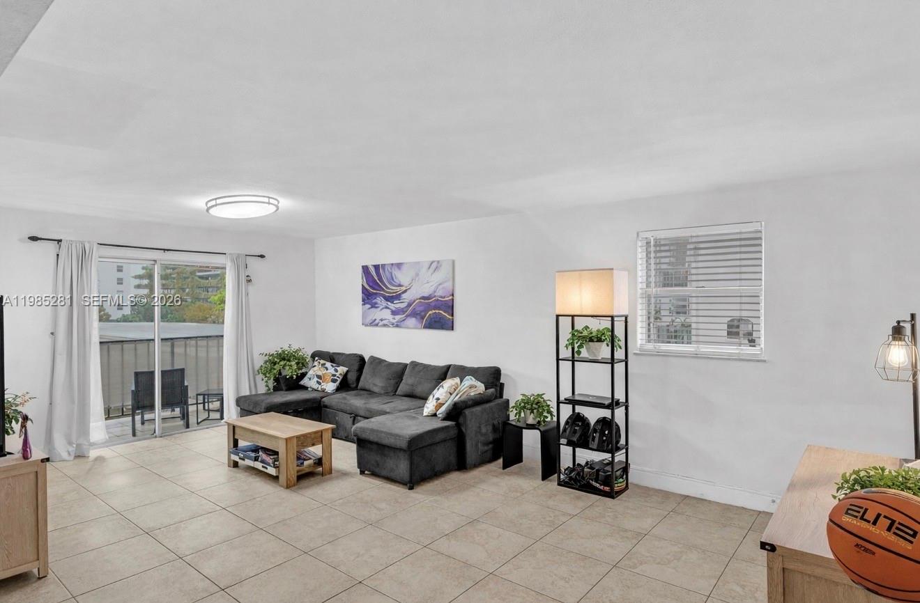 1236 Alton Road, Unit 304 Miami Beach, FL 33139 - Photo 3 of 28 a living room with furniture and a window