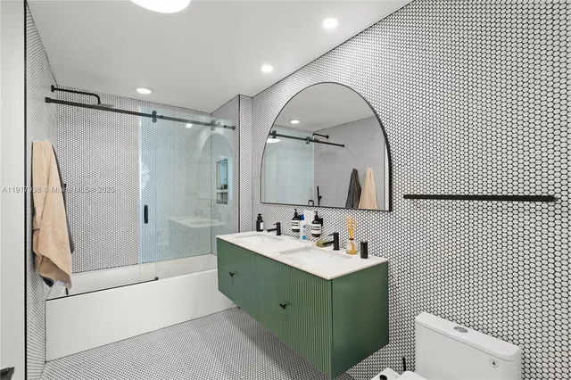 a bathroom with a sink mirror toilet and bathtub
