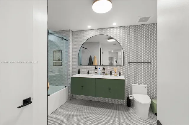 a bathroom with a toilet sink and mirror
