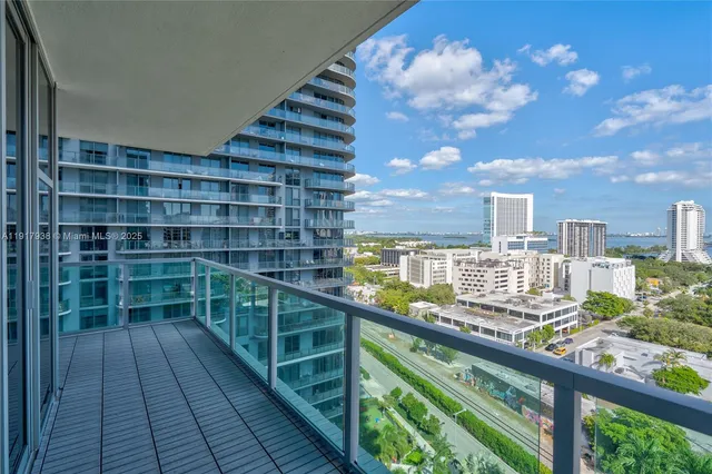 a view of a balcony with wooden floor and city view