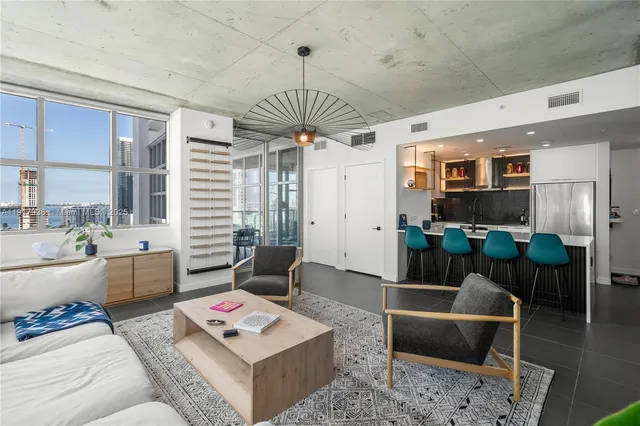 a living room with furniture a rug and a chandelier