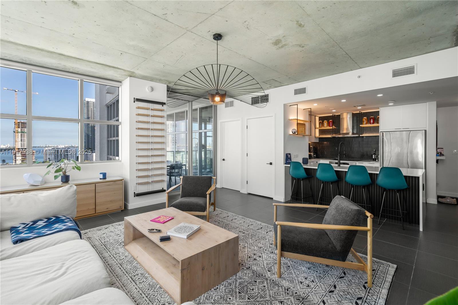 3301 Northeast 1st Avenue, Unit H1215 Miami, FL 33137 - Photo 3 of 45 a living room with furniture a rug and a chandelier