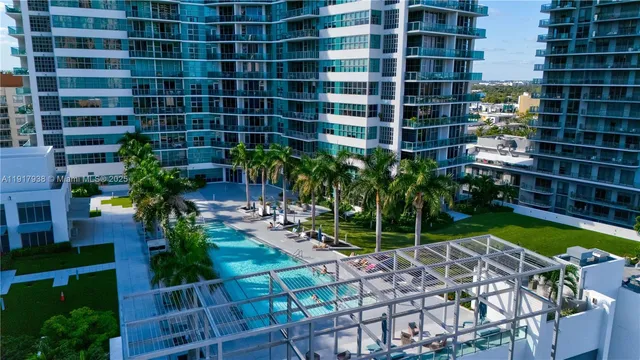a view of a flower garden with a building in the background