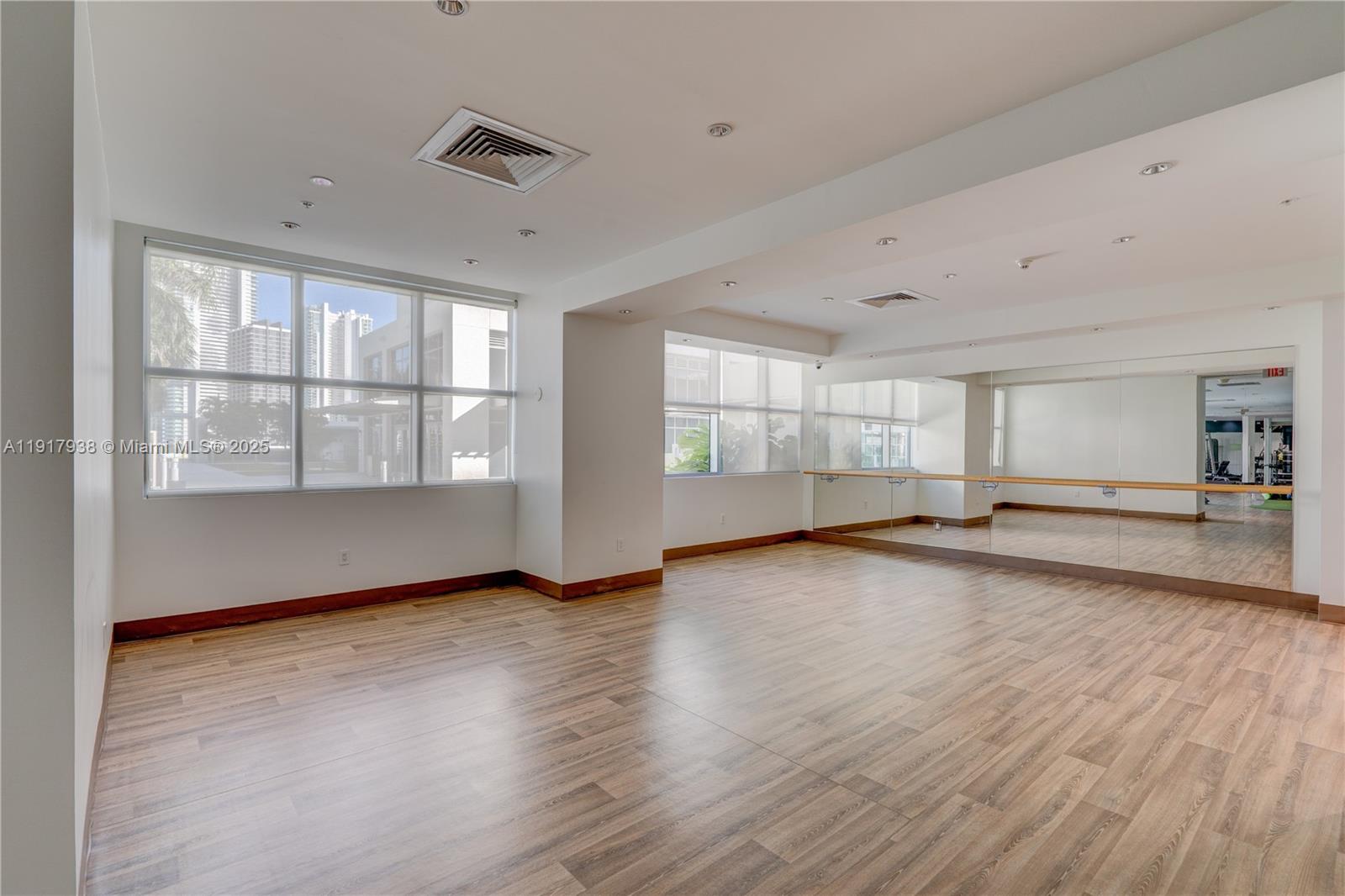 3301 Northeast 1st Avenue, Unit H1215 Miami, FL 33137 - Photo 45 of 45 a view of an empty room with a window and wooden floor