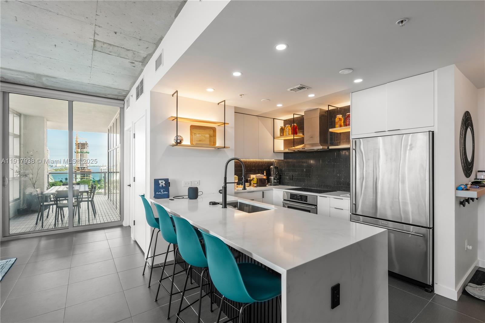 3301 Northeast 1st Avenue, Unit H1215 Miami, FL 33137 - Photo 6 of 45 a kitchen with a dining table chairs and refrigerator