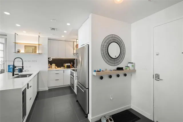 a kitchen with cabinets and window
