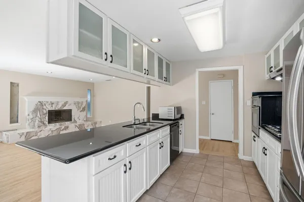 a kitchen with stainless steel appliances granite countertop a sink stove and cabinets