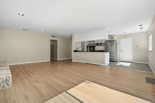a view of a kitchen with a sink and a refrigerator