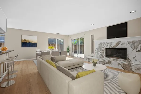 a living room with fireplace furniture and a flat screen tv