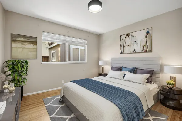 a bedroom with a bed and a painting on the wall