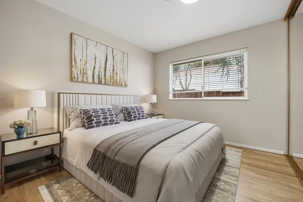 a bedroom with a bed and a night stand