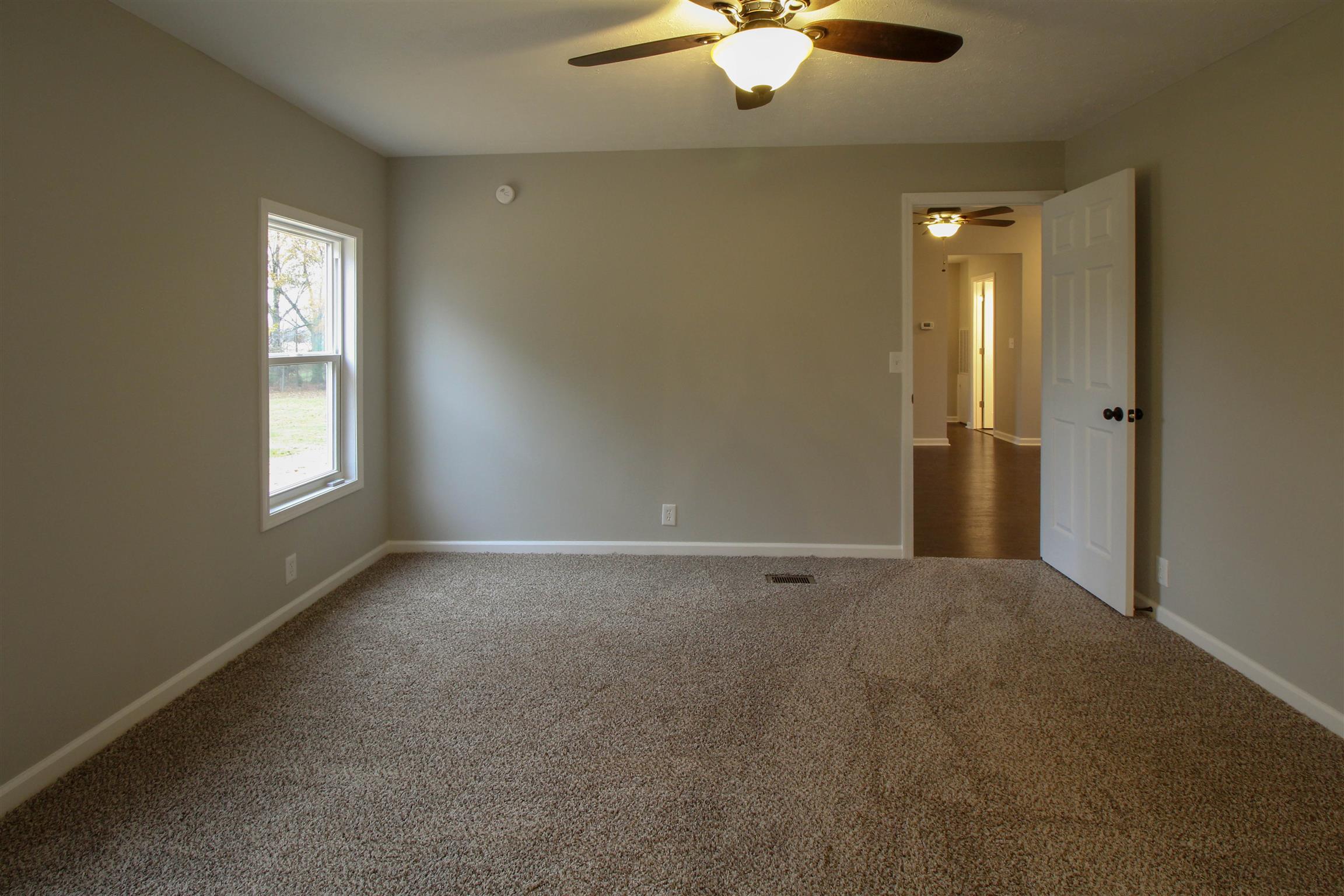 5647 Hopewell Road Springfield, TN 37172 - Photo 11 of 12 an empty room with windows and chandelier fan