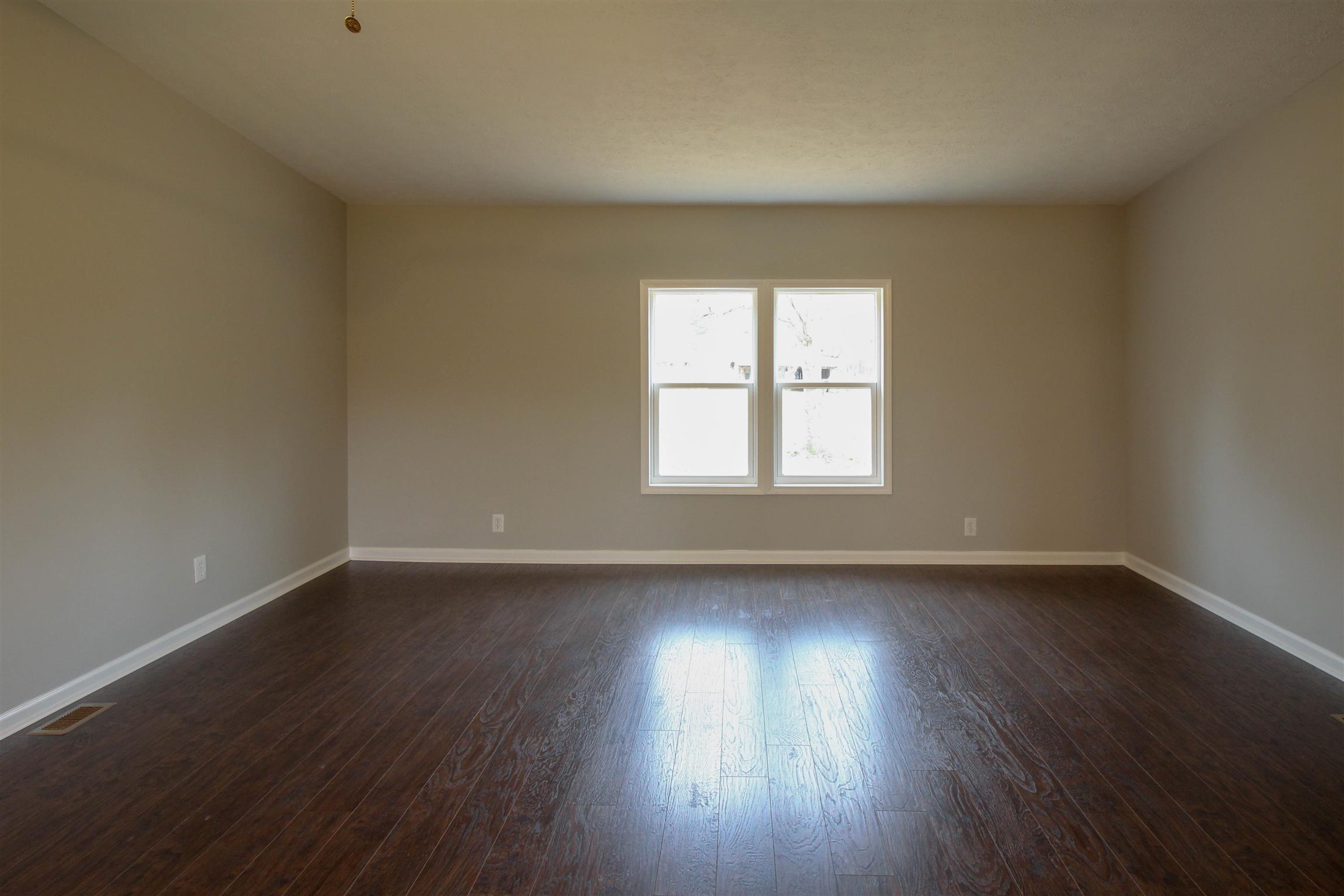 5647 Hopewell Road Springfield, TN 37172 - Photo 6 of 12 a view of an empty room with wooden floor and window