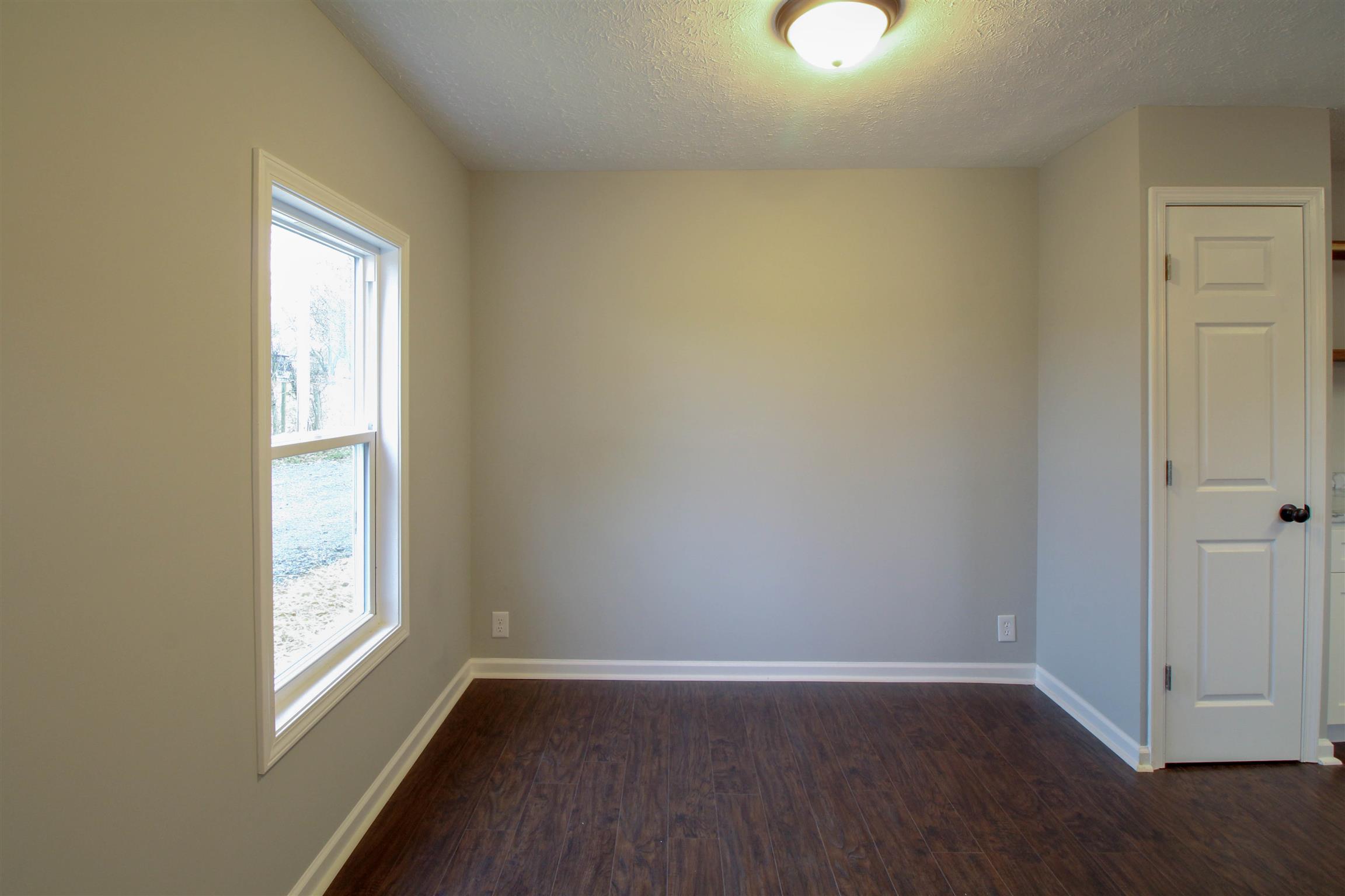 5647 Hopewell Road Springfield, TN 37172 - Photo 7 of 12 an empty room with wooden floor and windows