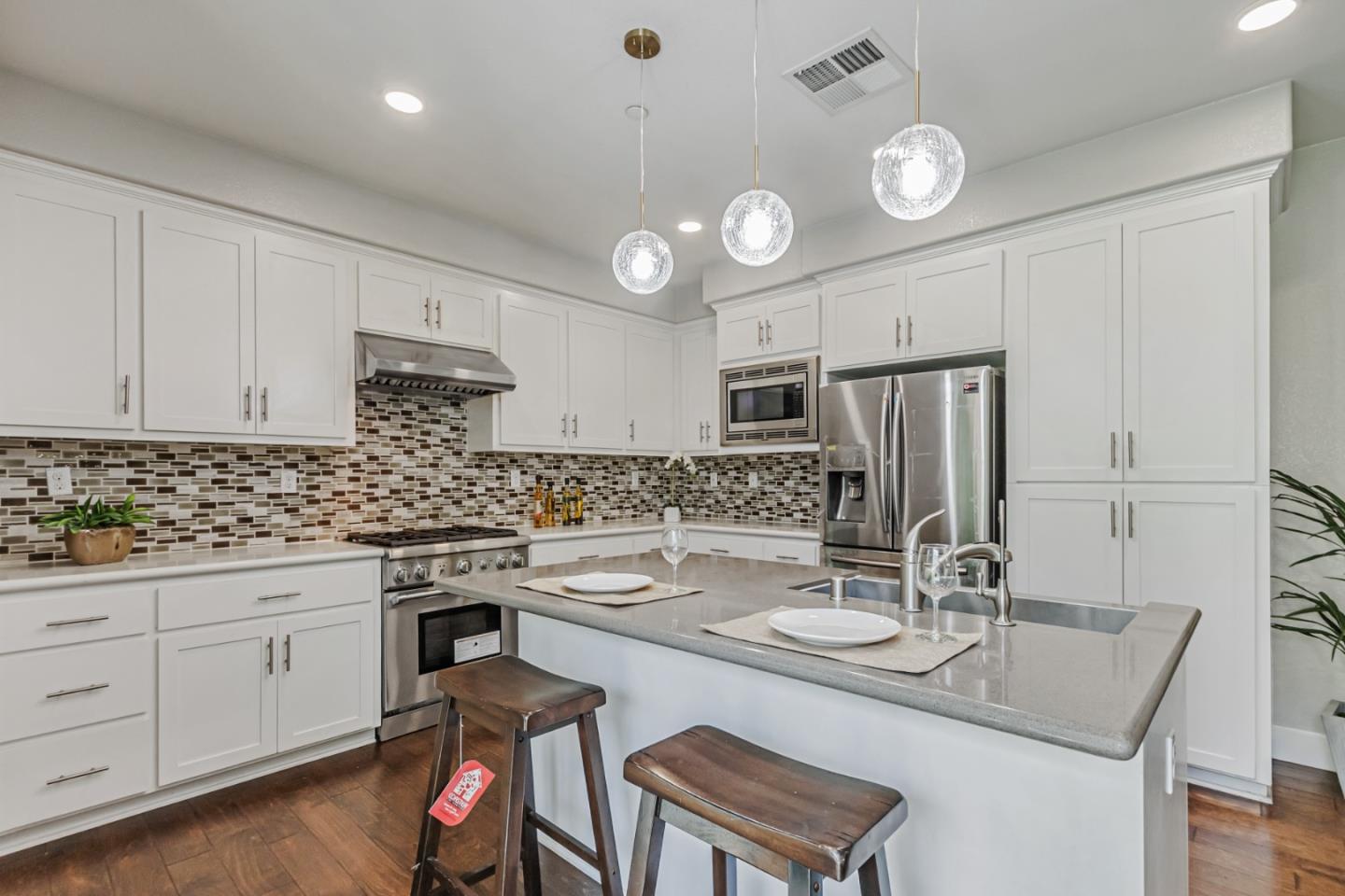 1633 Centre Pointe Drive Milpitas, CA 95035 - Photo 12 of 38 a kitchen with a sink stove and cabinets