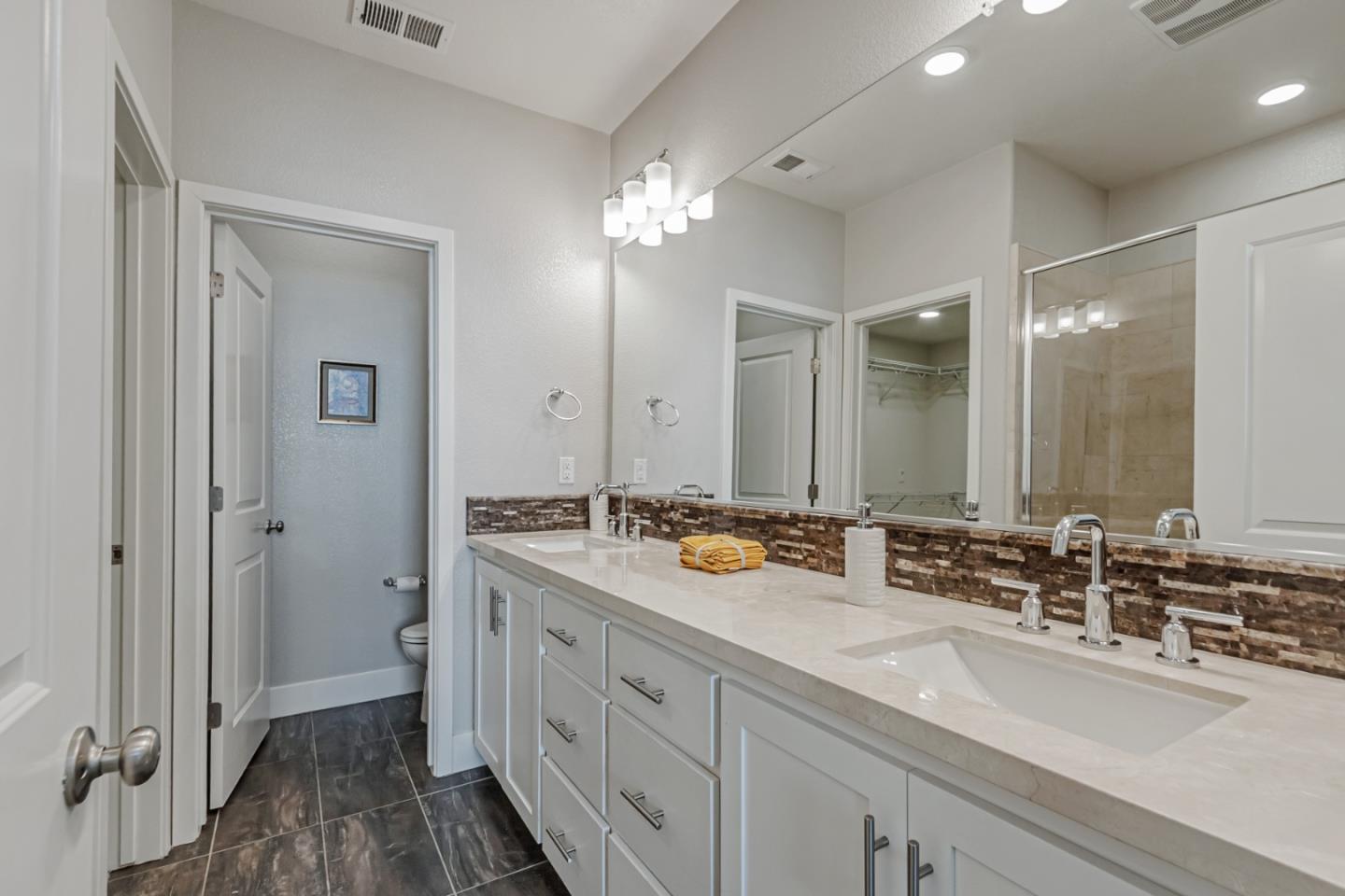 1633 Centre Pointe Drive Milpitas, CA 95035 - Photo 21 of 38 a bathroom with double vanity sinks and a mirror