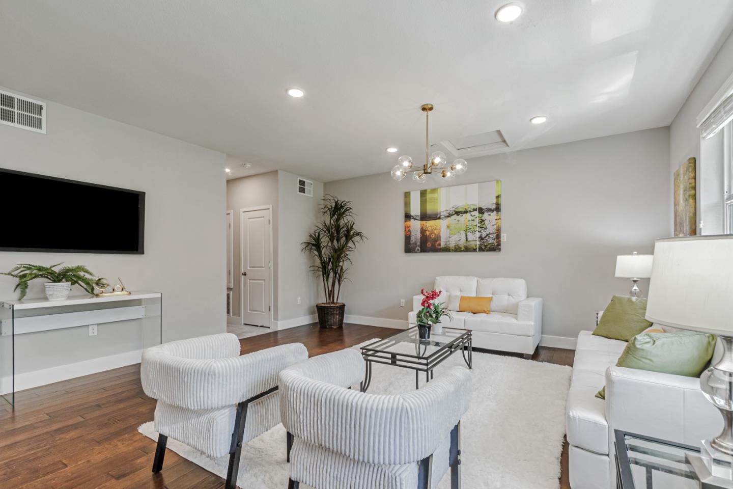 1633 Centre Pointe Drive Milpitas, CA 95035 - Photo 4 of 38 a living room with furniture and a flat screen tv