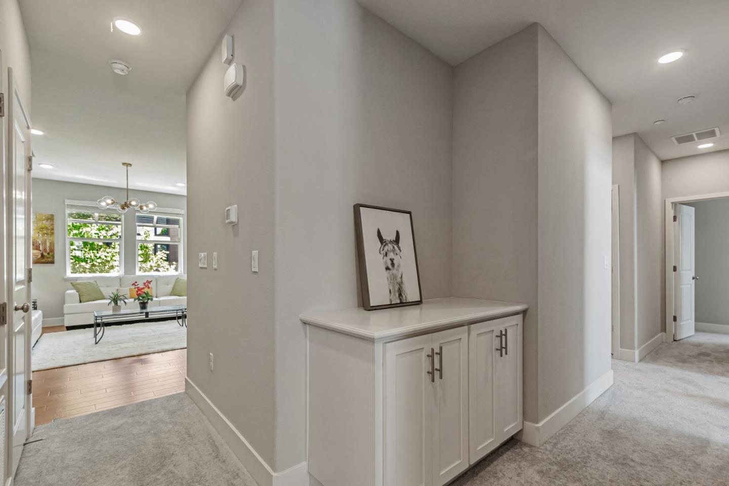 1633 Centre Pointe Drive Milpitas, CA 95035 - Photo 5 of 38 a view of a hallway to a room with wooden floor and windows