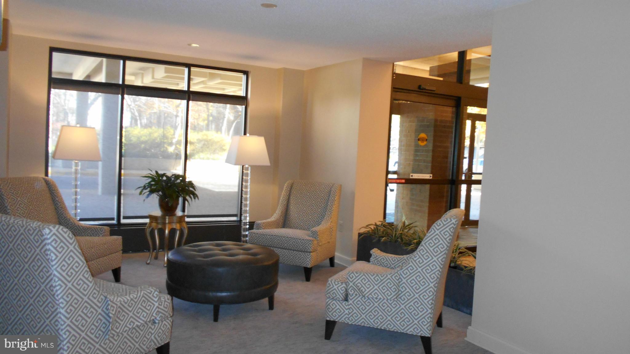 1808 Old Meadow Road, Unit 1003 McLean, VA 22102 - Photo 12 of 22 a living room with furniture and a large window