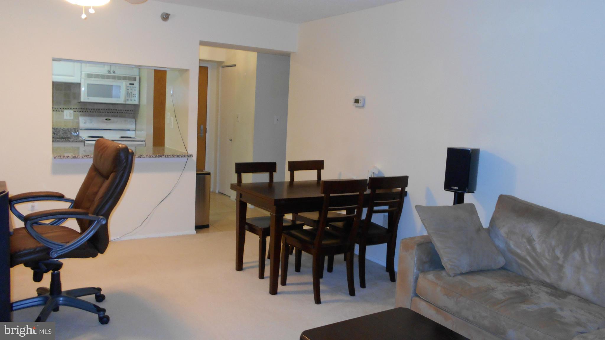 1808 Old Meadow Road, Unit 1003 McLean, VA 22102 - Photo 4 of 22 a view of a dining room with furniture and a window