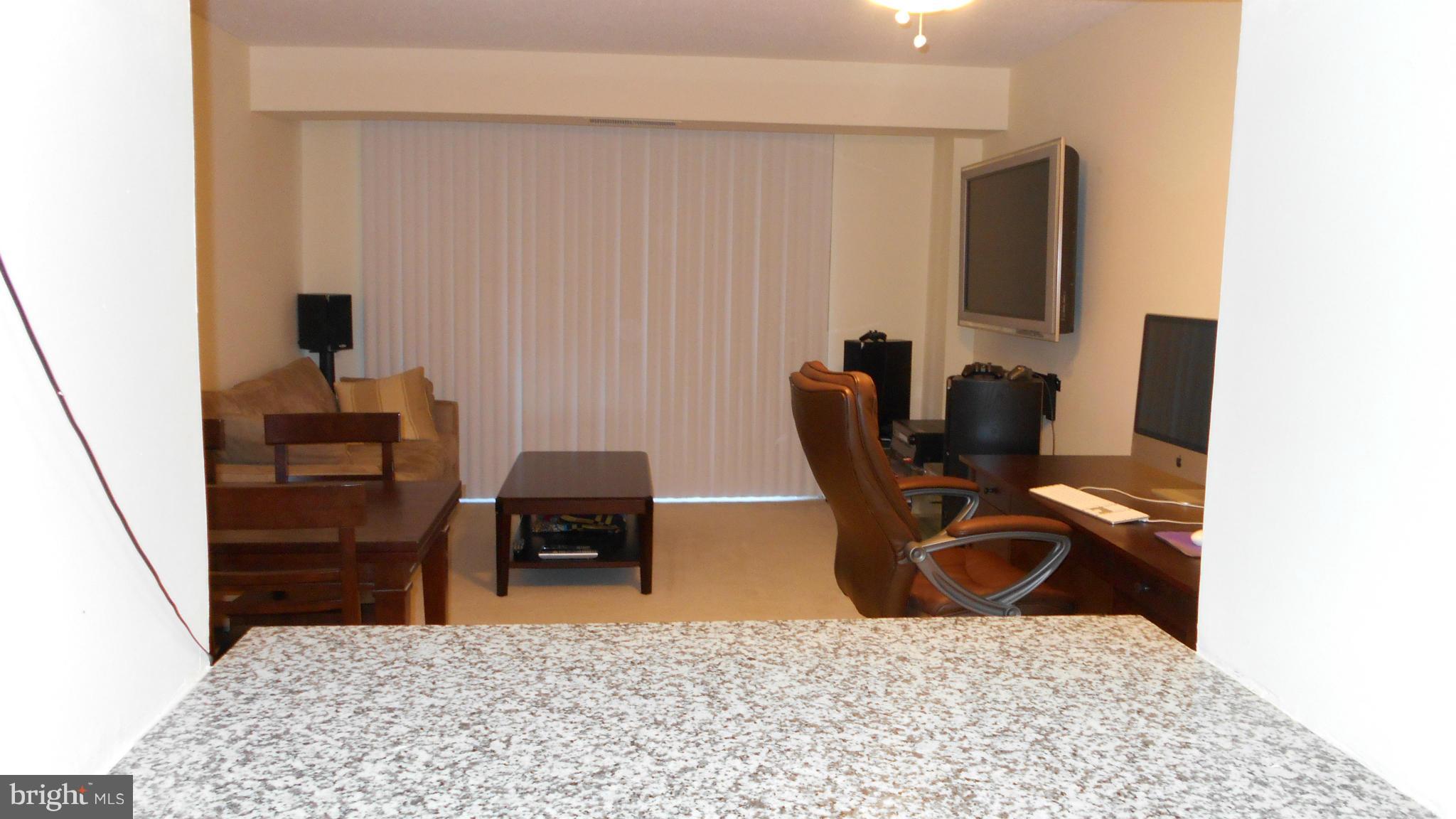 1808 Old Meadow Road, Unit 1003 McLean, VA 22102 - Photo 5 of 22 a living room with furniture and a flat screen tv