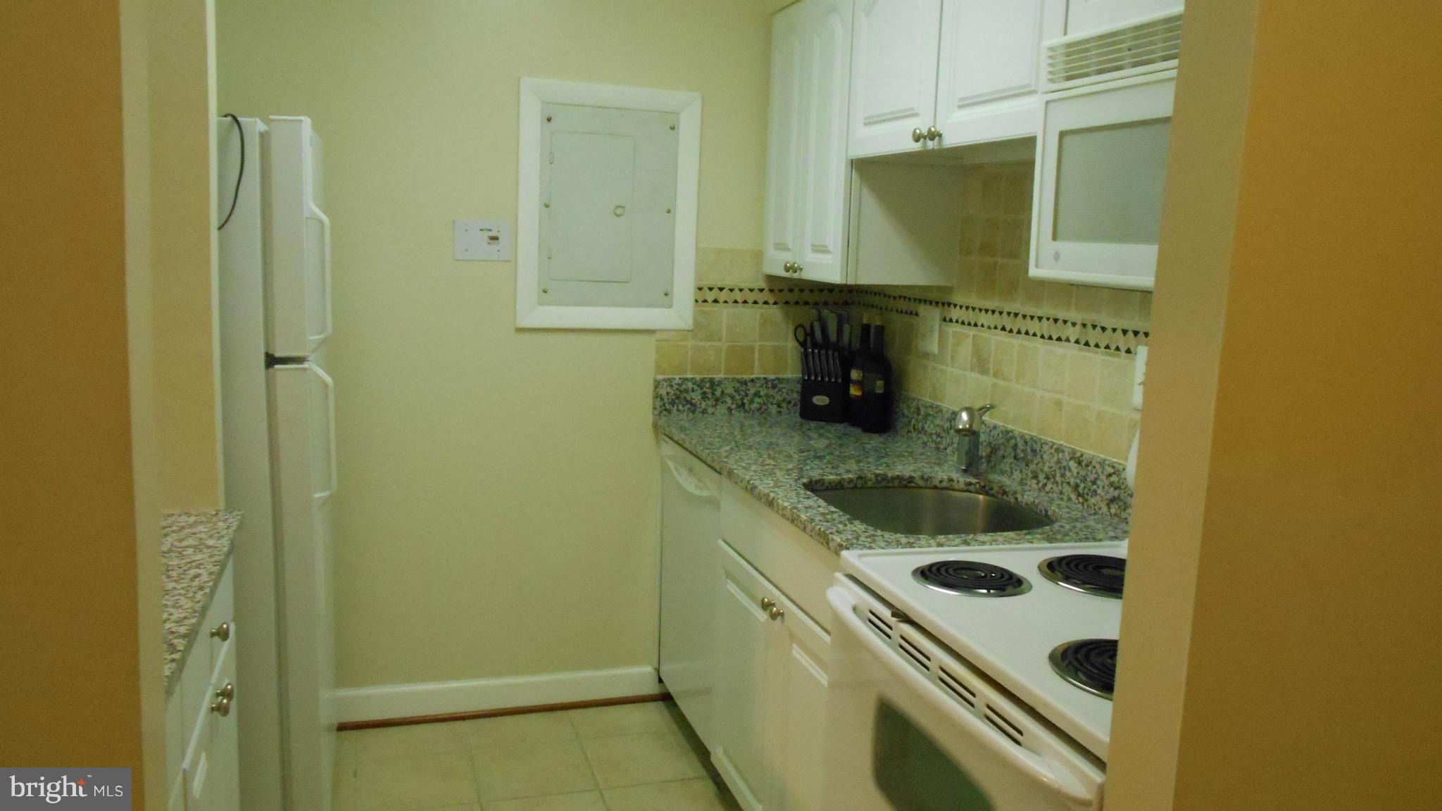 1808 Old Meadow Road, Unit 1003 McLean, VA 22102 - Photo 6 of 22 a bathroom with a granite countertop sink and a mirror