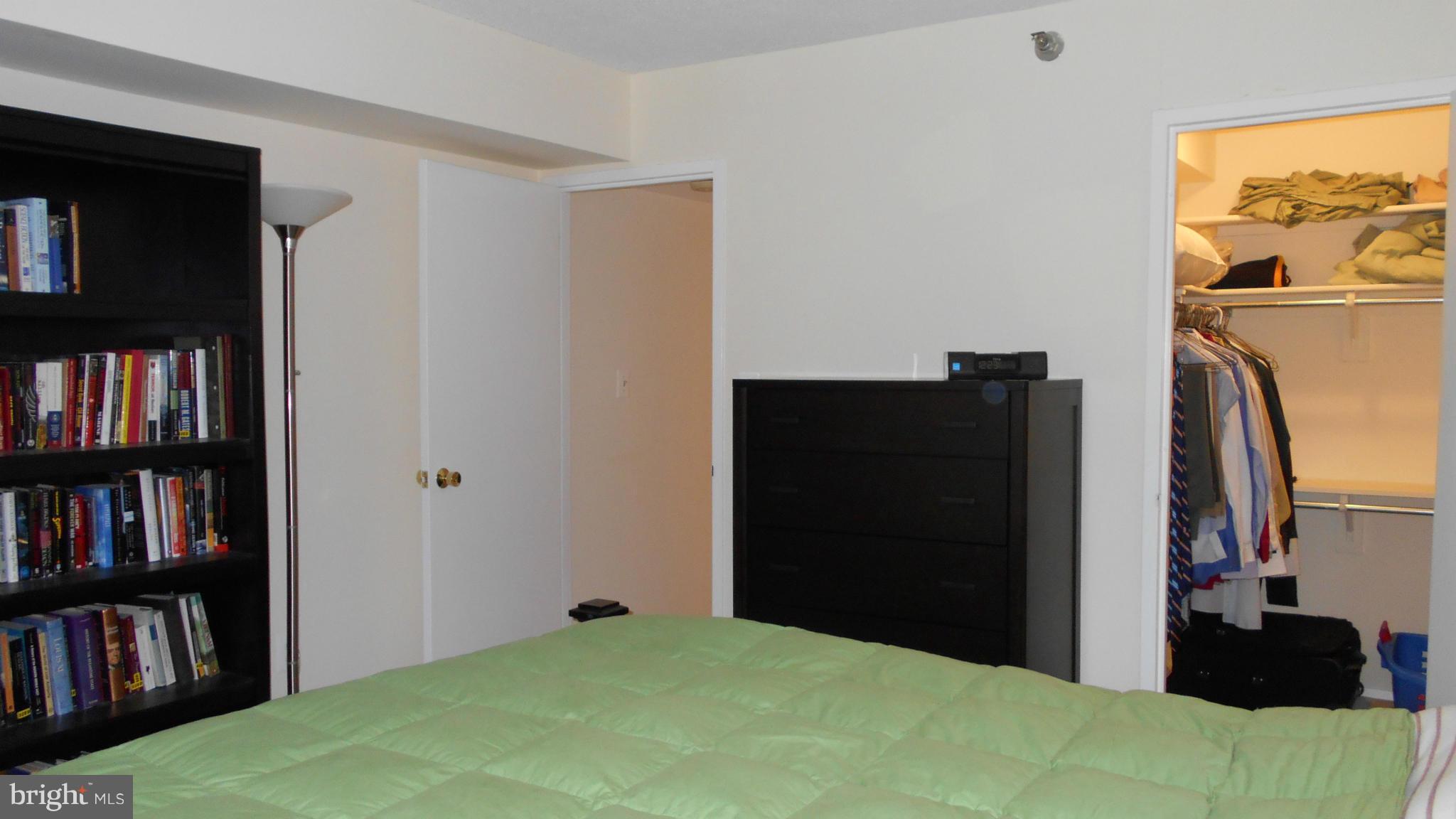 1808 Old Meadow Road, Unit 1003 McLean, VA 22102 - Photo 8 of 22 a bedroom with a bed and a book shelf