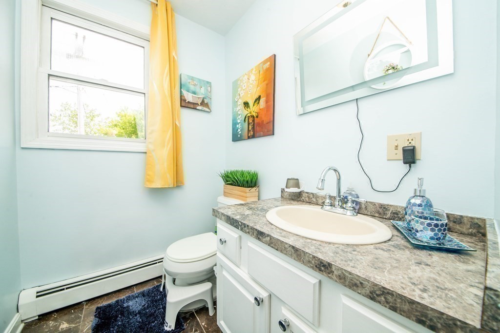 22 Michael Street, Unit 22 Fall River, MA 02721 - Photo 17 of 28 a bathroom with a granite countertop sink a toilet and a mirror