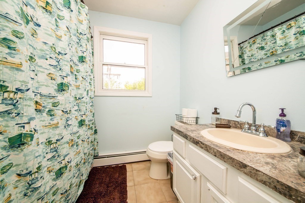 22 Michael Street, Unit 22 Fall River, MA 02721 - Photo 18 of 28 a bathroom with a granite countertop sink a toilet and a mirror