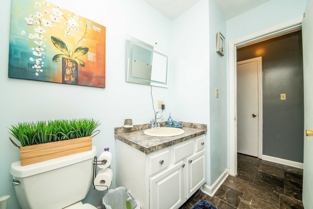 22 Michael Street, Unit 22 Fall River, MA 02721 - Photo 19 of 28 a bathroom with a granite countertop toilet sink and mirror