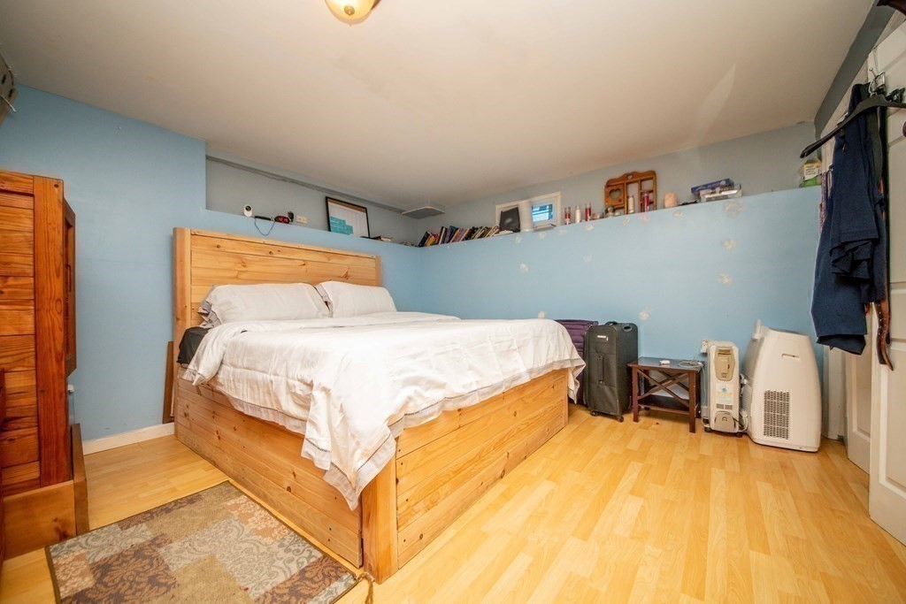 22 Michael Street, Unit 22 Fall River, MA 02721 - Photo 27 of 28 a bedroom with a bed and wooden floor