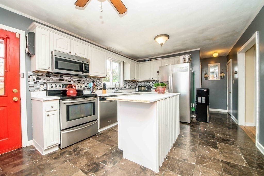 22 Michael Street, Unit 22 Fall River, MA 02721 - Photo 8 of 28 a kitchen with microwave a stove and cabinets