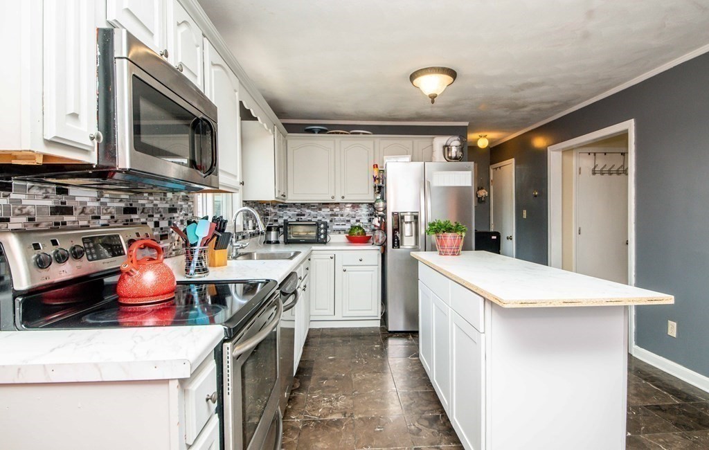 22 Michael Street, Unit 22 Fall River, MA 02721 - Photo 9 of 28 a kitchen that has a sink and a stove in it