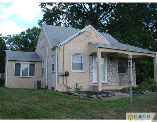 216 New Dover Road, Unit 216 Colonia, NJ 07067 - Photo 1 of 10 a view of a white house with yard and plants