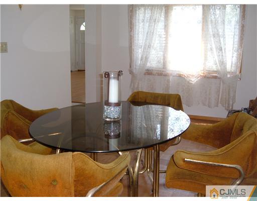 216 New Dover Road, Unit 216 Colonia, NJ 07067 - Photo 4 of 10 a living room with furniture and a table