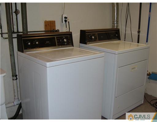 216 New Dover Road, Unit 216 Colonia, NJ 07067 - Photo 10 of 10 a utility room with dryer and washer