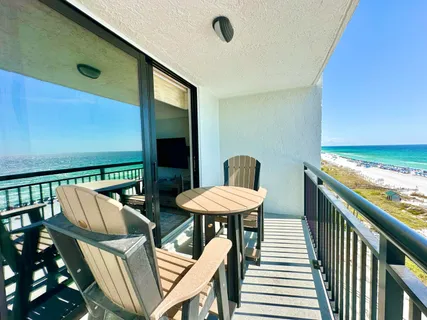 a balcony with table and chairs