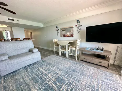 a living room with furniture and wooden floor