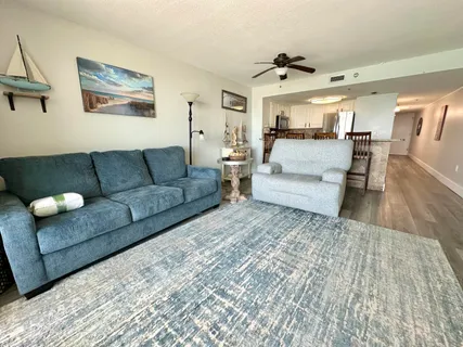 a kitchen with stainless steel appliances granite countertop a sink a stove a refrigerator a dining table and chairs