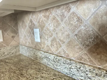 a kitchen with granite countertop a stove oven and a sink with cabinets