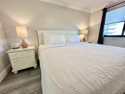 a large bed sitting in a bedroom and chandelier