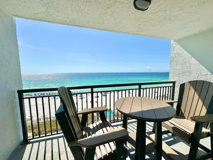 a view of a chairs and table in the balcony