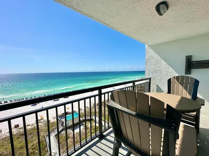 a view of balcony with wooden floor and seating space