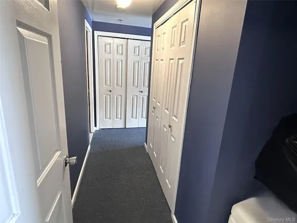 a view of a hallway with a wooden door