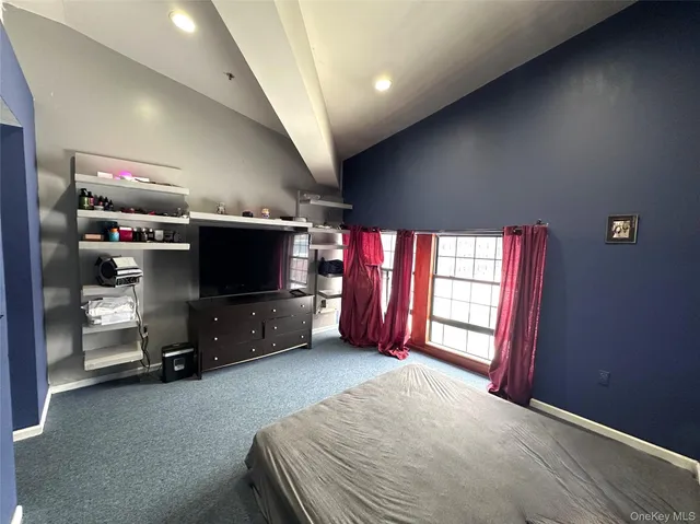 a bedroom with furniture and a flat screen tv