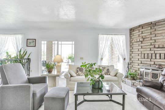 712 East Kendall Avenue Ridgecrest, CA 93555 - Photo 13 of 50 a living room with furniture and a large window