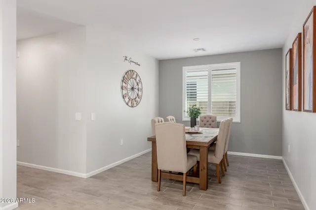 a view of a dining room with furniture and a window