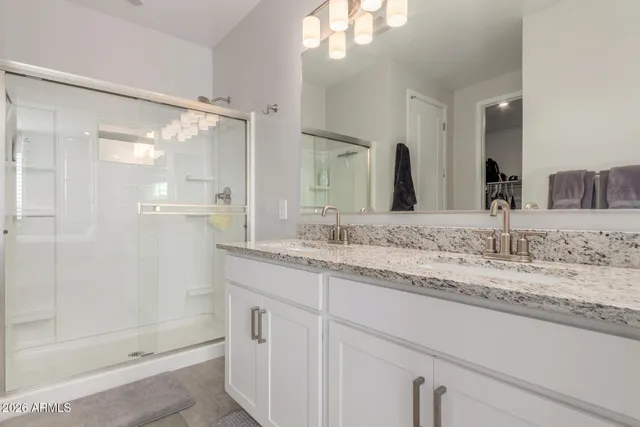 a bathroom with a granite countertop sink mirror and double